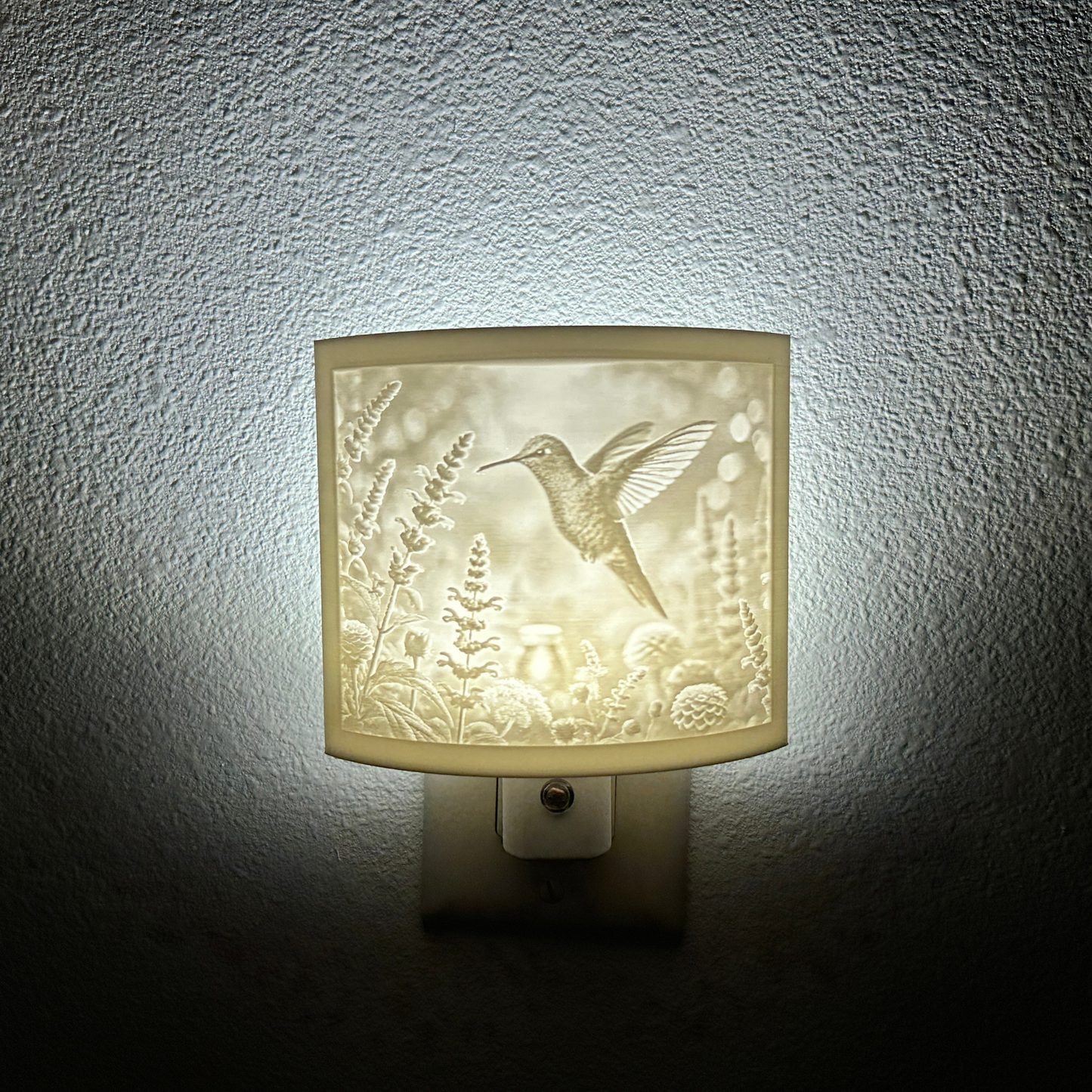 White hummingbird lithophane night light featuring a detailed hummingbird hovering among blooming flowers, softly glowing curved nature-inspired decor for bedrooms, hallways, nurseries, or garden-themed spaces.