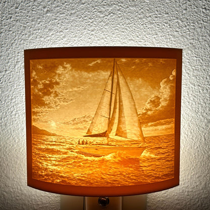 Warm glowing sailboat lithophane night light with detailed ocean waves and dramatic sunset sky, curved nautical lamp decor for coastal bedroom, hallway, or beach house ambiance.