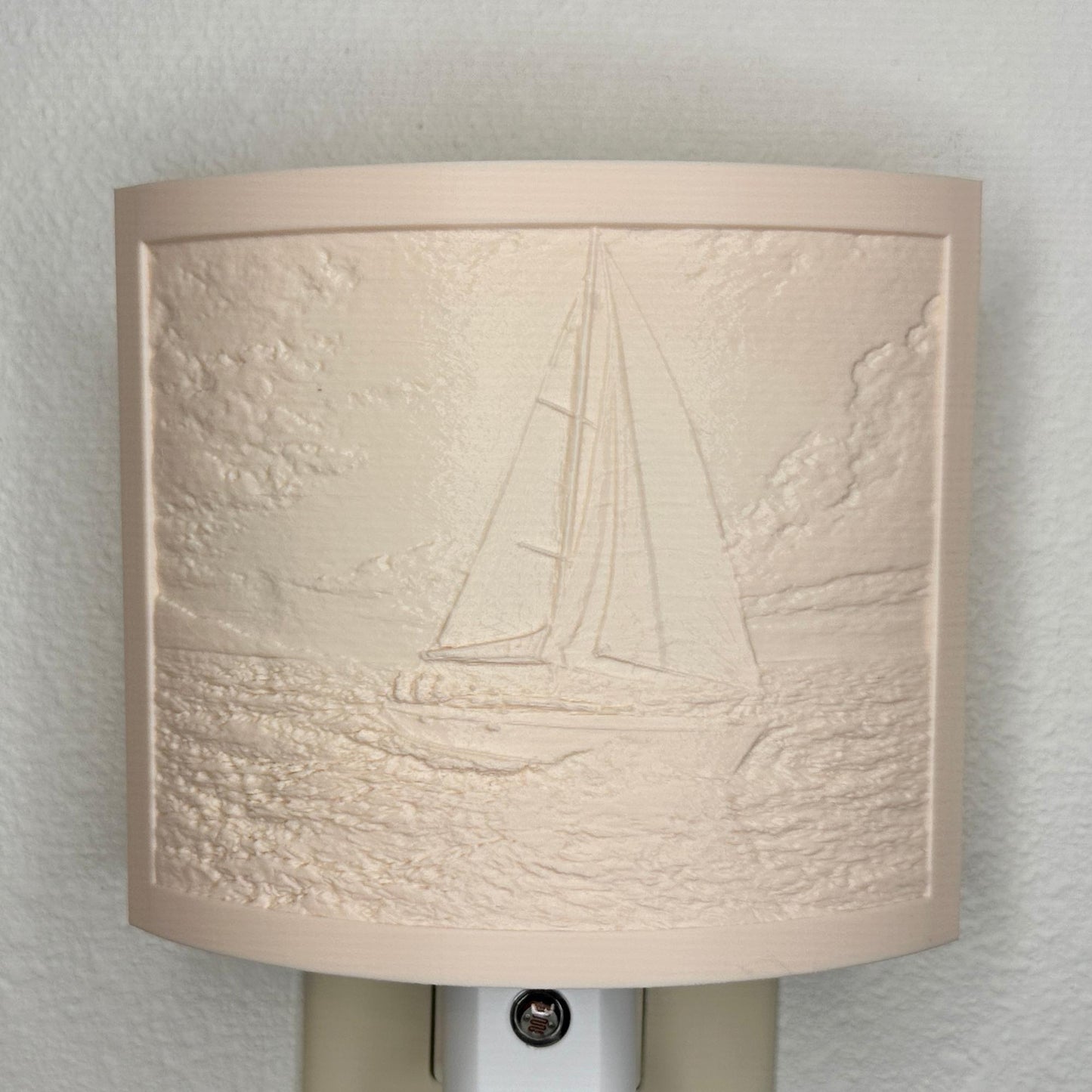 Beige sailboat lithophane night light with embossed ocean sailing scene, featuring detailed waves, clouds, and a sailboat, curved nautical decor for coastal bedrooms, hallways, or beach house spaces.