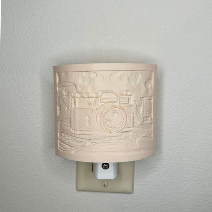 Beige camera lithophane night light with embossed vintage-style camera design on a tabletop scene, curved photography-themed decor for bedrooms, offices, studios, or camera enthusiasts.