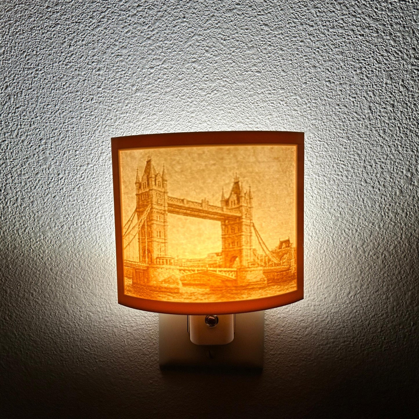 Warm glowing Tower Bridge lithophane night light featuring a detailed London bridge cityscape, curved travel-themed decor for bedrooms, offices, hallways, or England and architecture lovers.