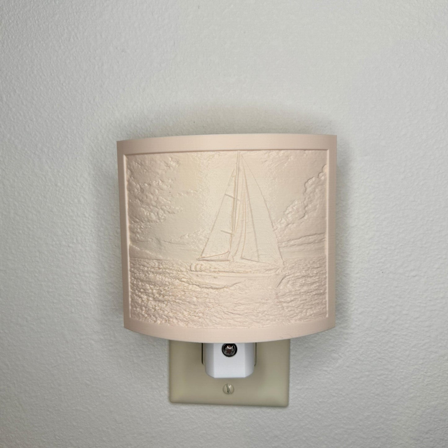 Beige sailboat lithophane night light with embossed ocean sailing scene, featuring detailed waves, clouds, and a sailboat, curved nautical decor for coastal bedrooms, hallways, or beach house spaces.