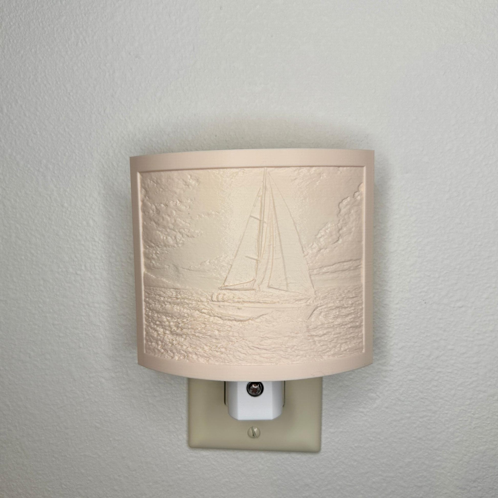 Beige sailboat lithophane night light with embossed ocean sailing scene, featuring detailed waves, clouds, and a sailboat, curved nautical decor for coastal bedrooms, hallways, or beach house spaces.