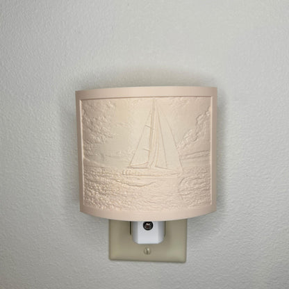 Beige sailboat lithophane night light with embossed ocean sailing scene, featuring detailed waves, clouds, and a sailboat, curved nautical decor for coastal bedrooms, hallways, or beach house spaces.