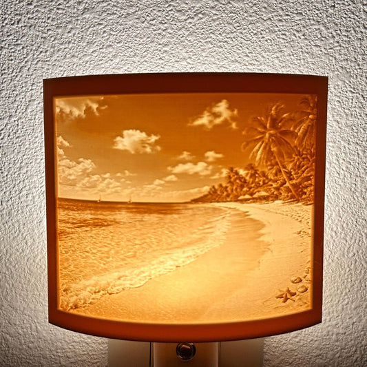 Warm glowing tropical beach lithophane night light featuring palm trees, ocean waves, sandy shoreline, and seashell details, curved coastal decor for bedrooms, bathrooms, beach houses, or relaxing spaces.