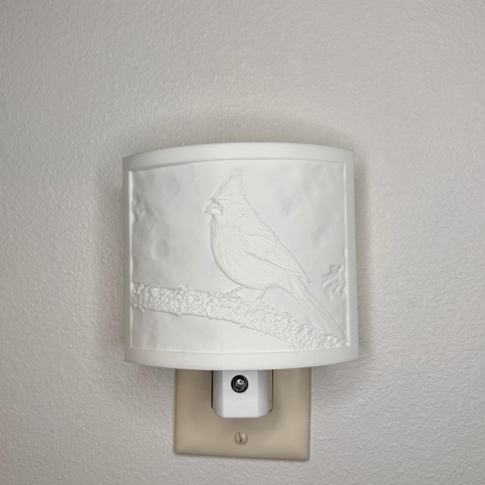 White cardinal lithophane night light with embossed bird design featuring a cardinal perched on a tree branch, curved nature-inspired wall decor for bedrooms, hallways, cabins, or cozy living spaces.