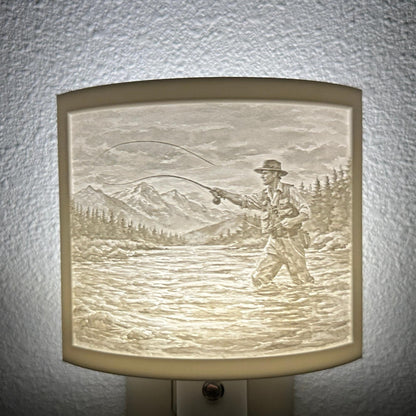 White fishing lithophane night light featuring a fly fisherman casting in a mountain river with forest and mountain scenery, softly glowing curved outdoor-themed decor for cabins, lodges, fishing enthusiasts, or rustic spaces.