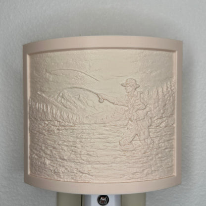 Beige fishing lithophane night light with embossed fly fisherman casting in a mountain river surrounded by forest and mountain scenery, curved outdoor-themed decor for cabins, lodges, fishing enthusiasts, or rustic spaces.