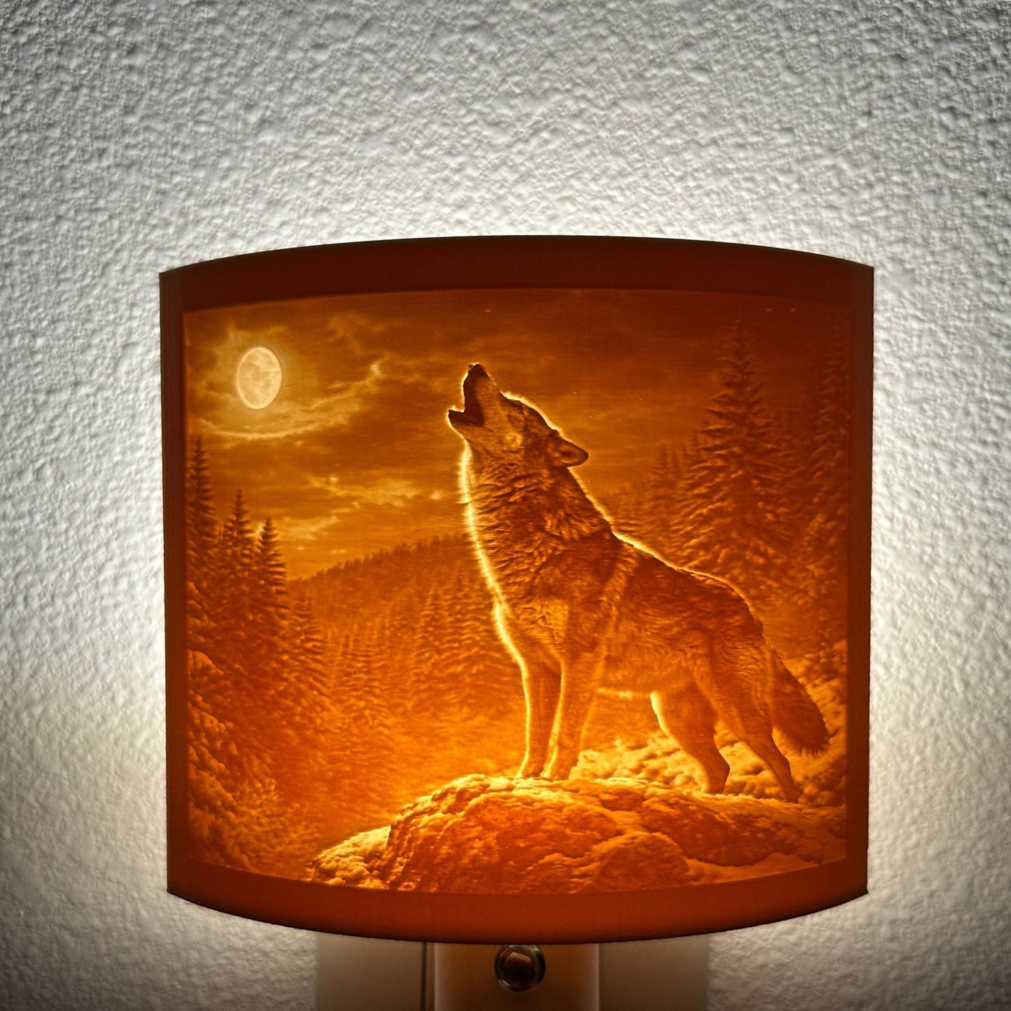 Warm glowing wolf lithophane night light featuring a detailed howling wolf under a full moon in a forest landscape, curved wildlife-themed decor for bedrooms, cabins, lodges, or rustic spaces.