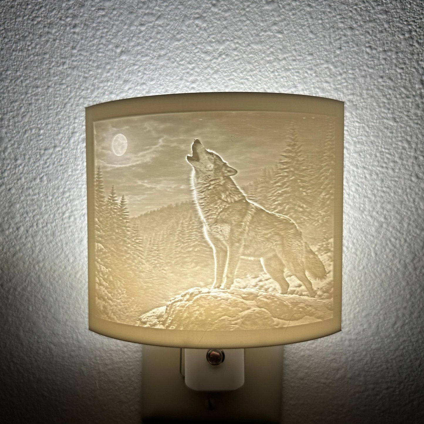White wolf lithophane night light featuring a detailed howling wolf beneath a full moon in a forest landscape, softly glowing curved wildlife-themed decor for bedrooms, cabins, lodges, or rustic spaces.