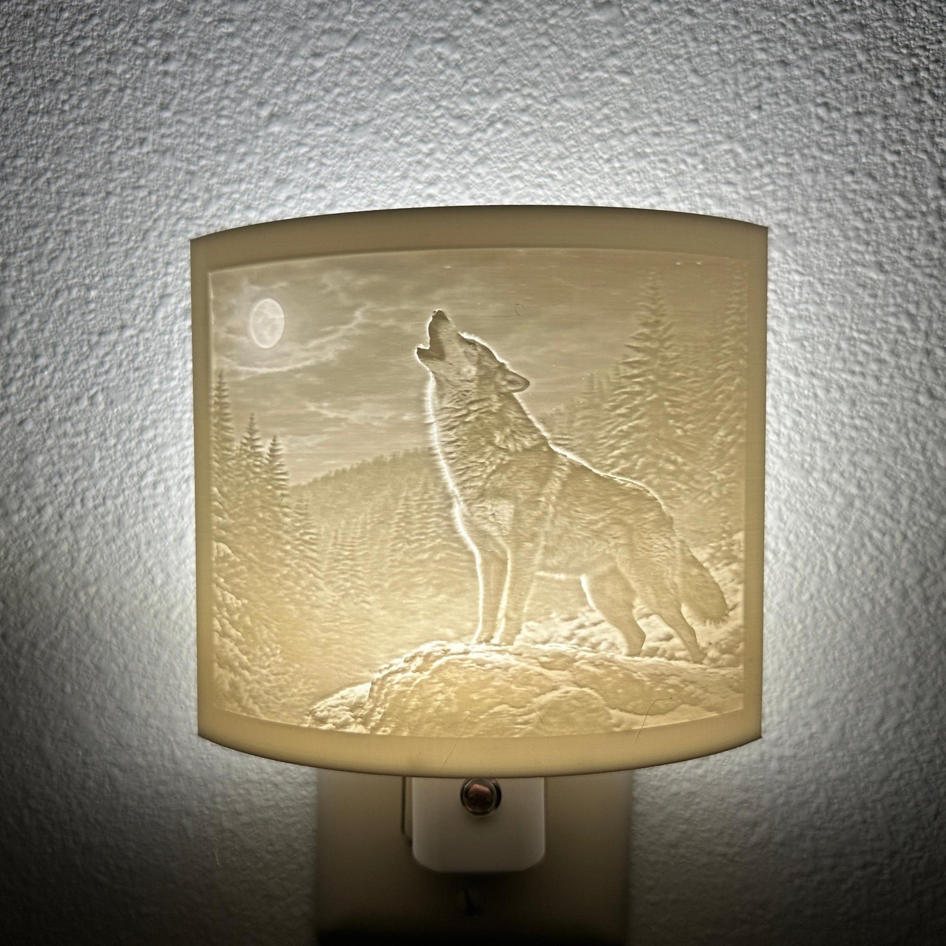 White wolf lithophane night light featuring a detailed howling wolf beneath a full moon in a forest landscape, softly glowing curved wildlife-themed decor for bedrooms, cabins, lodges, or rustic spaces.