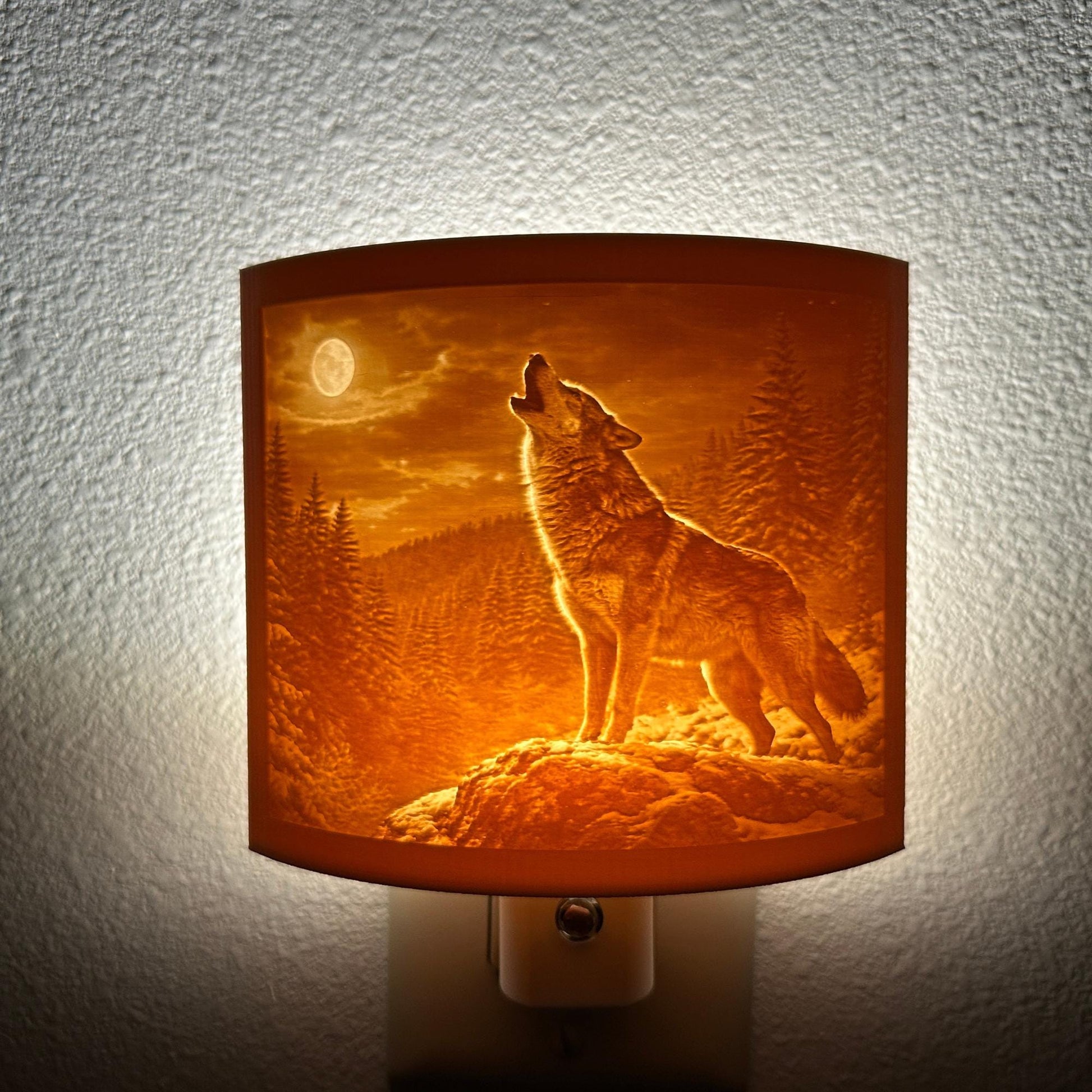 Warm glowing wolf lithophane night light featuring a detailed howling wolf under a full moon in a forest landscape, curved wildlife-themed decor for bedrooms, cabins, lodges, or rustic spaces.