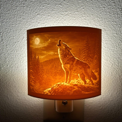 Warm glowing wolf lithophane night light featuring a detailed howling wolf under a full moon in a forest landscape, curved wildlife-themed decor for bedrooms, cabins, lodges, or rustic spaces.