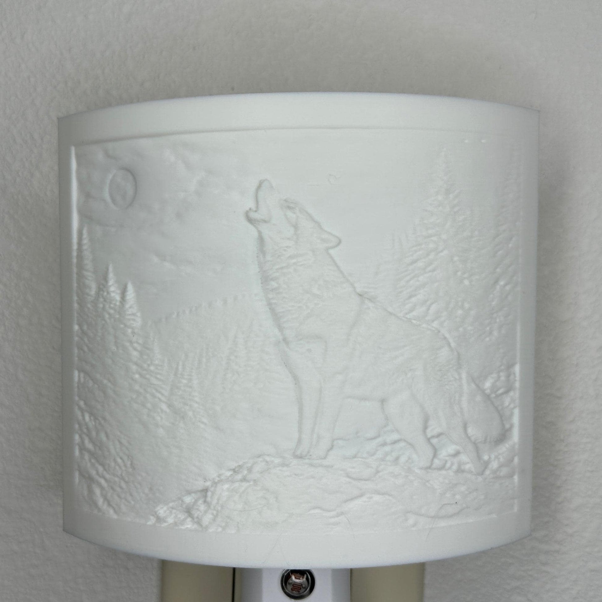 White wolf lithophane night light with embossed howling wolf beneath a full moon in a forest landscape, curved wildlife-themed decor for bedrooms, cabins, lodges, or rustic spaces.